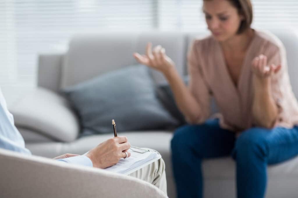 therapist making notes patient